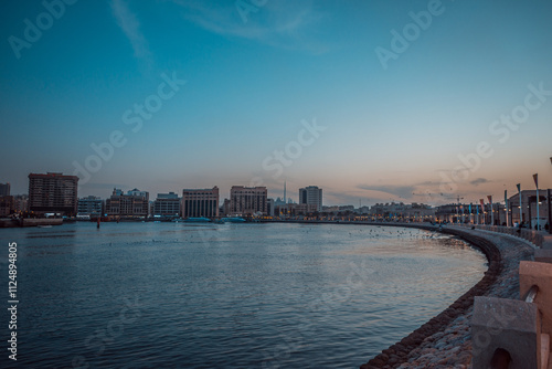 Wallpaper Mural Waterfront Cityscape: A calm city waterfront scene, with a view of modern architecture and a serene water body in the foreground Torontodigital.ca