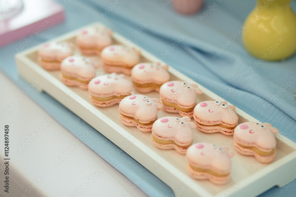 Fototapeta premium macaroons in the form of a pig on a glass plate.