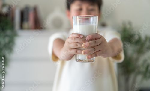 Asian boy drinking milk for healthy growth in protein and calcium, promoting strong bones natural nutrition development, wellness vitality dairy beverage, happy childhood lifestyle, family care fresh