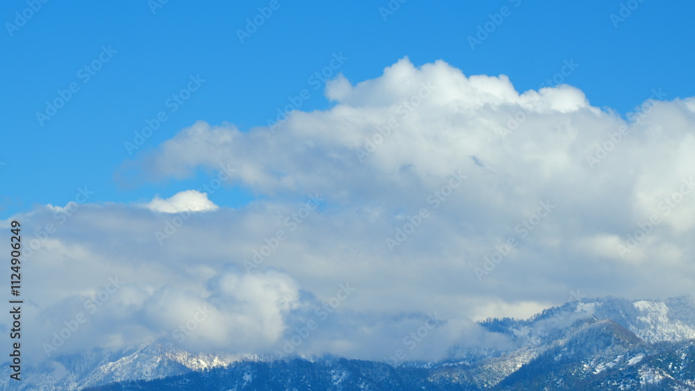 Snow Mountain With Opposite Direction Clouds. Clouds Running On Blue Sky Over Amazing White Landscape. Timelapse.
