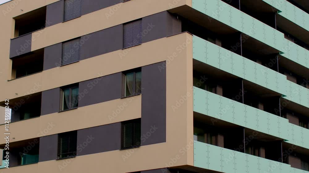 A view of a contemporary apartment building with attractive balconies and modern glass features