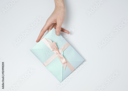 Hand holding blue gift envelope