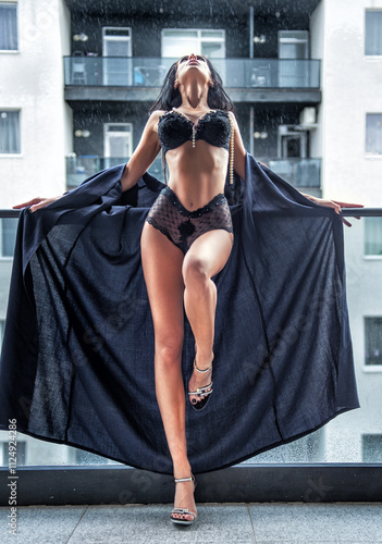 Obraz na płótnie Beautiful brunette woman in black lingerie posing in the city. Elegant and sensual brunette girl with long hair in black lingerie posing on the roof. w salonie