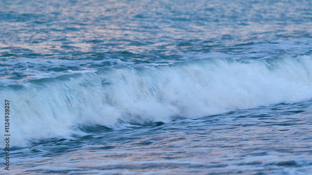Fototapeta premium Dawn Sky Over Serene Ocean Surf. Sunlight Reflect On Water Surface. Calm Marine Scenery. Static view.