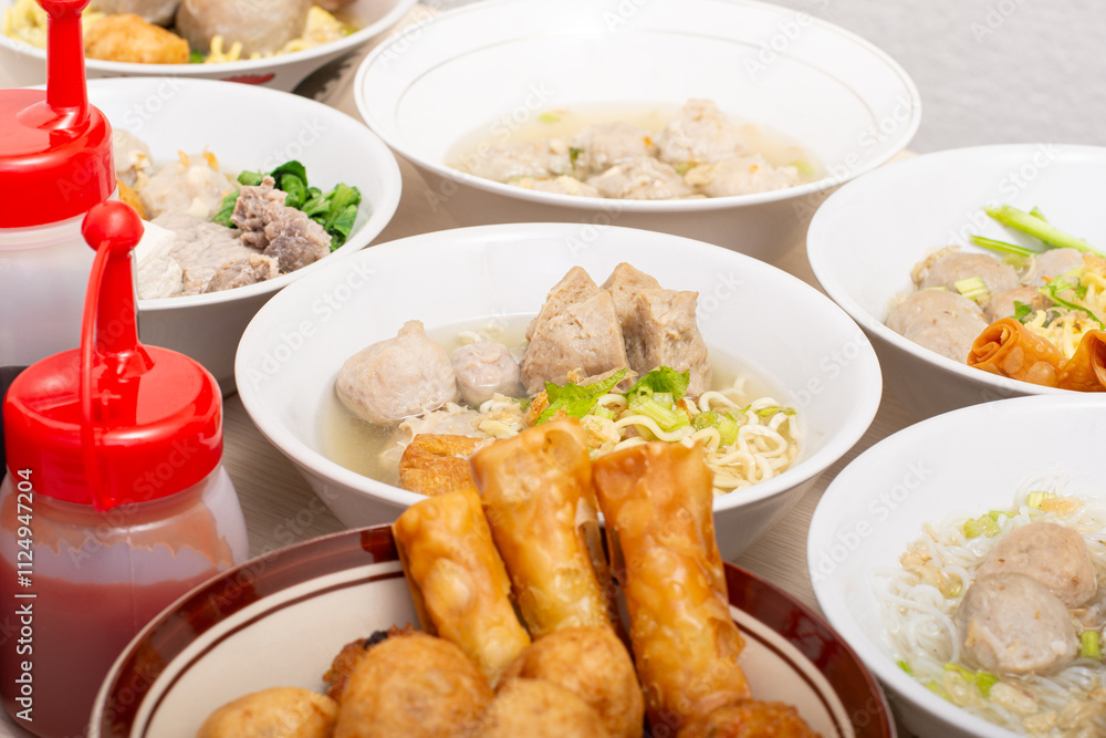 Bakso sapi, Various beef meatballs with accompaniments on wooden table. Most popular Indonesian foods Bakso sapi, Various beef meatballs with accompaniments on wooden table. Most popular Indonesian foods
