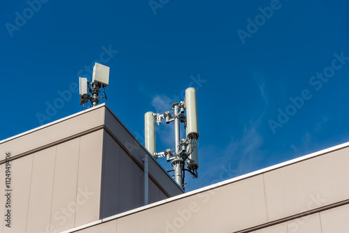 Cell site, cellular network 5G antenna on the building roof. photo