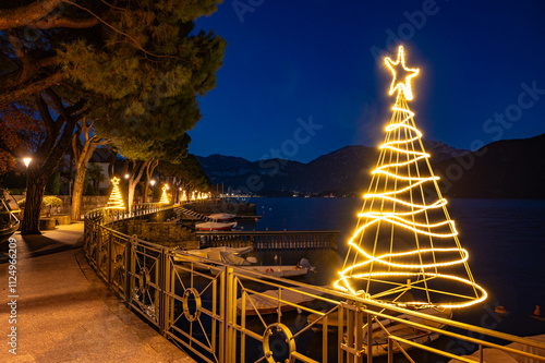 The lakeside of Lenno, on Lake Como, photographed at dusk, with Christmas lights and decorations. photo