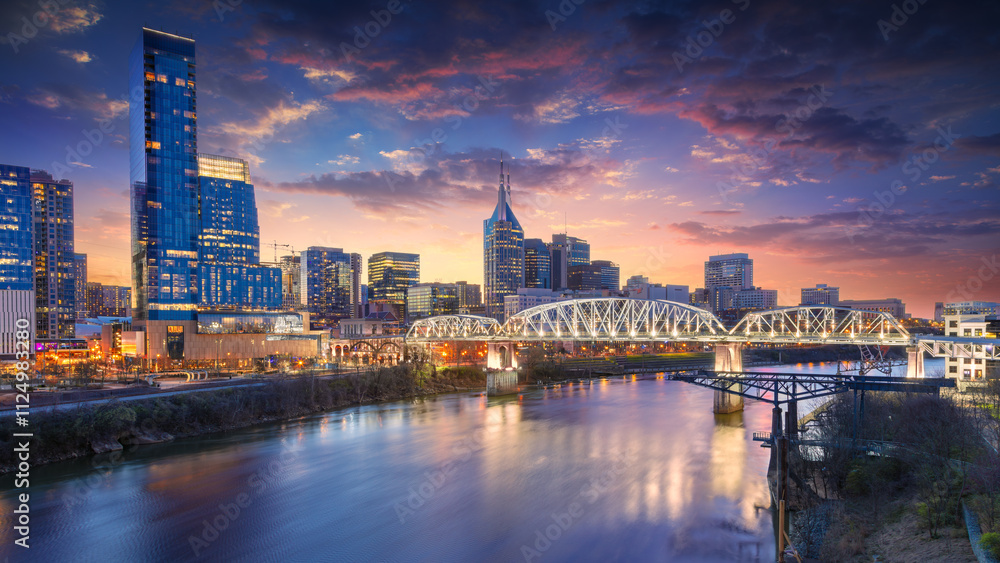 Nashville, Tennessee, USA. Cityscape image of Nashville, Tennessee, USA downtown skyline with reflection of the city the Cumberland River at spring sunset.