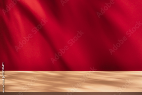 Empty table on bright pink wall background. Composition with leaves shadow on red the wall and beige table. Mock up for presentation, branding products, cosmetics, food or jewelry.	