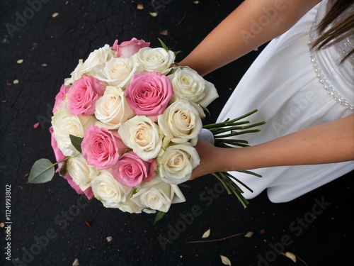 Close-Up Aerial Photography of Delicate White and Pink Roses Held by Women's Hands Against a Dramatic Black Background, Perfect for Floral and Nature Themes