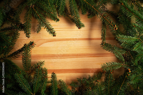 Christmas background. Fir branches on a wooden background. New Year and Christmas decorations as a festive background.