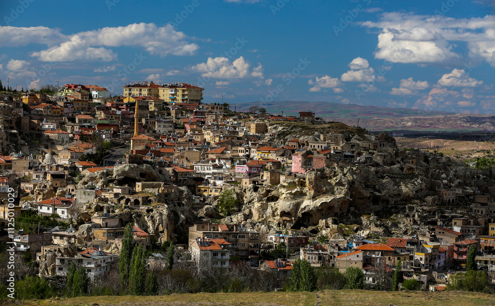 Naklejka premium Cappadocia is a semi-desert region in central Turkey. It is famous for its fairy chimneys - tall cone-shaped rock formations, which are especially numerous in Pasabag Monks Valley and Goreme Valley.