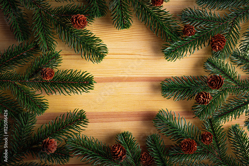 Obraz na płótnie Christmas background. Fir branches on a wooden background. New Year and Christmas decorations as a festive background. w salonie