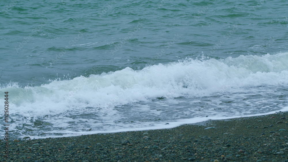 Sea Surface Seashore. Turquoise Ocean Waves Crashing Onto Shore And Forming Foam Patterns. Slow motion. Sea Surface Seashore. Turquoise Ocean Waves Crashing Onto Shore And Forming Foam Patterns. Slow motion.