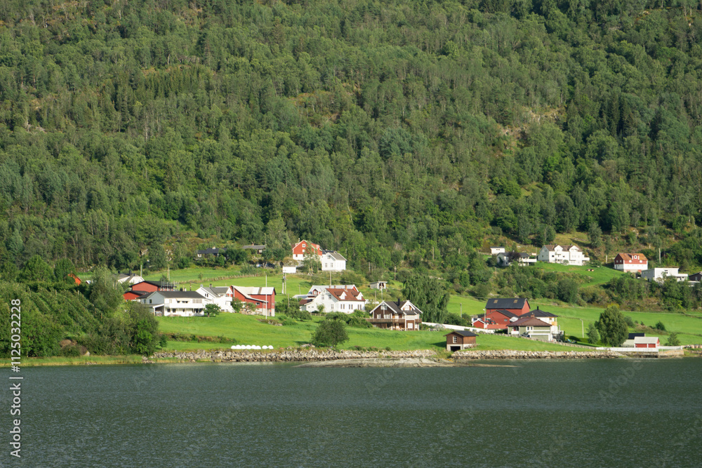 A picturesque village in western Norway nestled by a fjord, surrounded by lush green forests and hills, featuring traditional wooden houses and a serene atmosphere A picturesque village in western Norway nestled by a fjord, surrounded by lush green forests and hills, featuring traditional wooden houses and a serene atmosphere