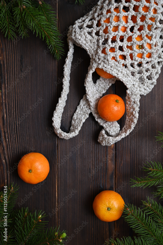 tangerines fall out of the eco bag on the wooden table tangerines fall out of the eco bag on the wooden table