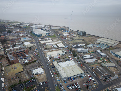 Aerial view of the costal town of Lowestoft, Suffolk, UK. Showing the North Sea defences and wind turbine seen in the industrial area of the city. photo