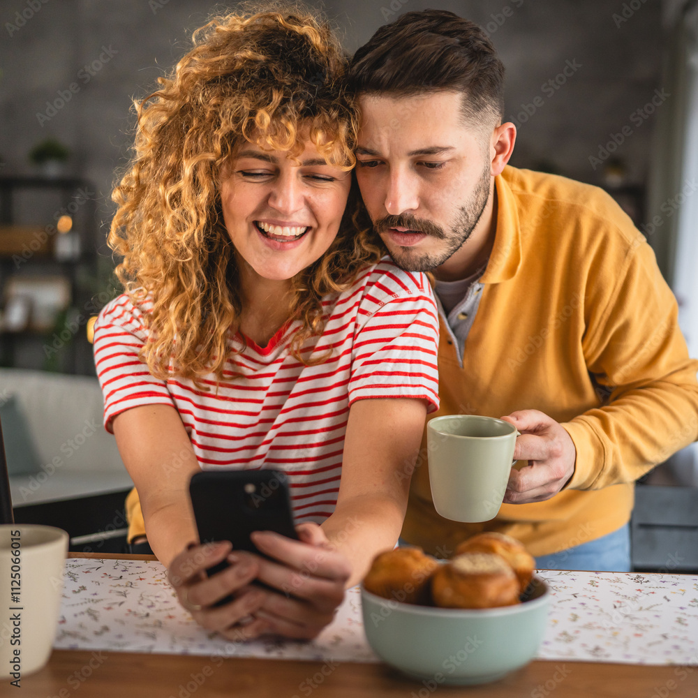 husband hug wife on breakfast while she use cellphone morning routine