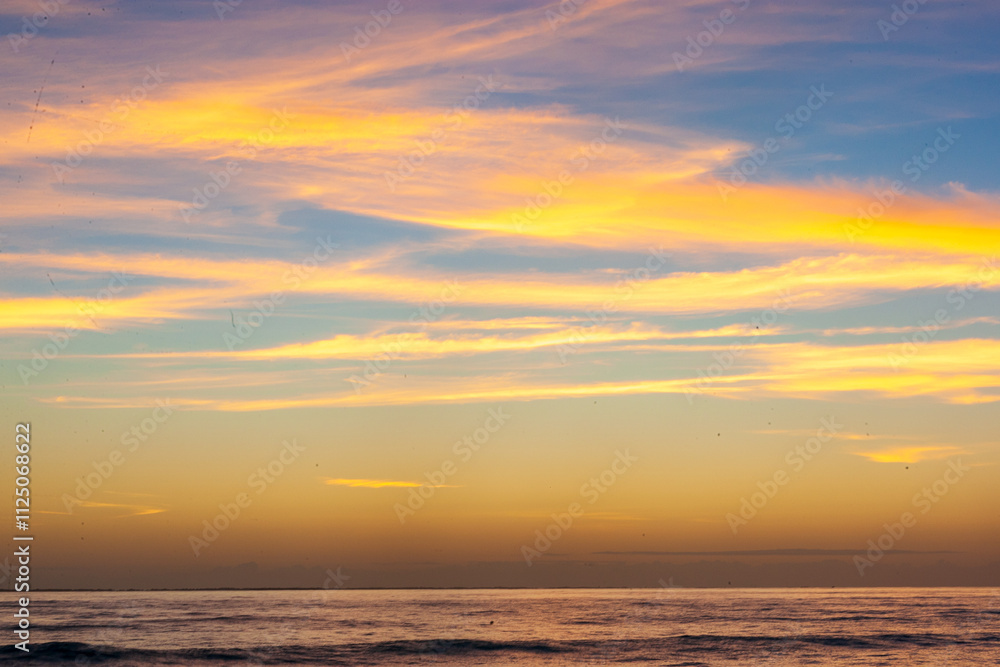 Dramatic Sunset Over Calm Ocean With Vibrant Clouds In The Sky Dramatic Sunset Over Calm Ocean With Vibrant Clouds In The Sky