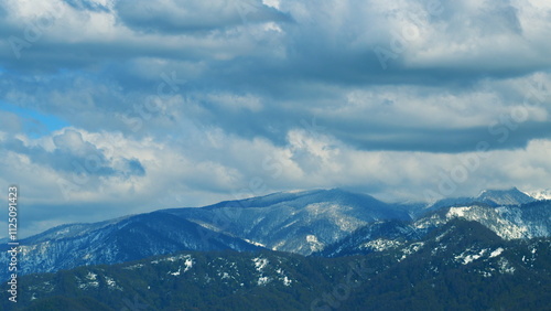 The Sun s Rays Showed The Texture Of The Mountains. Trees On Mountain Slope. Timelapse. photo