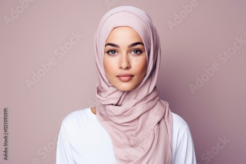 A woman wearing a pink scarf with a white shirt