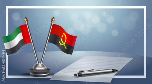 United Arab Emirate and Angola National flags on small table with bokeh background, cooperative relationship
