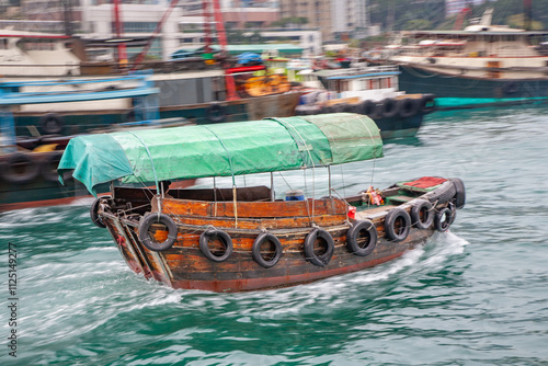 Photography a junk water taxi in the Harbor of ABerdeen at the istalnd of Victoria in Hongko