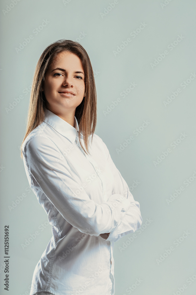 Young businesswoman posing with crossed arms and smiling Young businesswoman posing with crossed arms and smiling