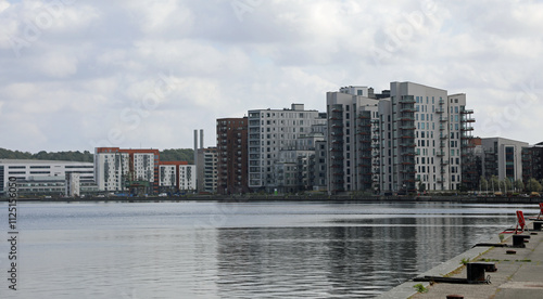 Konstfotografi tall skyscrapers of the residential and office complex near the sea and the pier