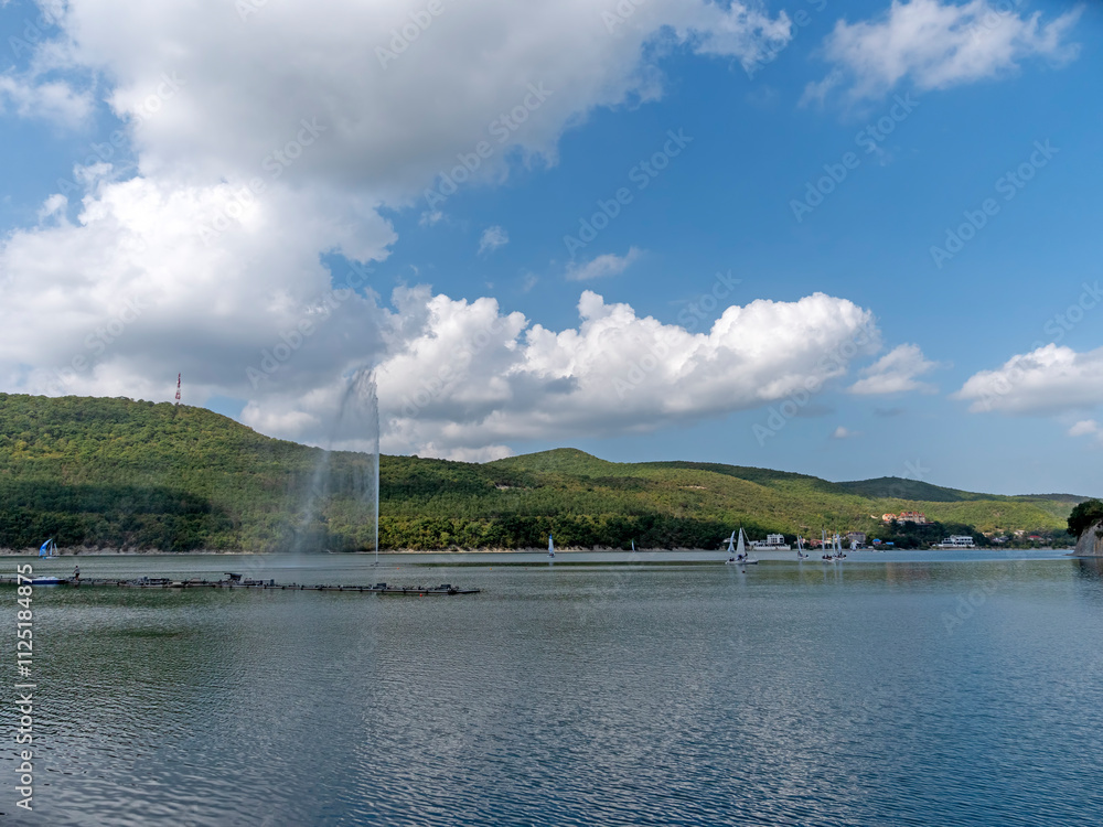 Fototapeta premium Abrau Durso, Russia 28 August 2024: Picturesque view of embankment of lake Abrau on sunny day in Abrau Durso