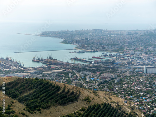 Panoramic view of Novorossiysk City and Tsemess Bay at sunrise. Morning cityscape of large port at Black Sea coast in Russia photo