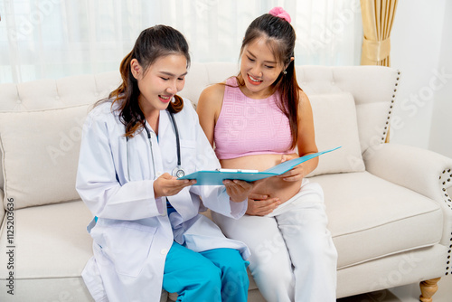 Doctor or nurse sit together with Asian pregnancy  woman and discuss abouth mother health at home with happiness. photo