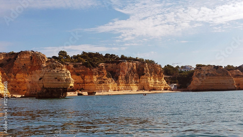 The awesome Marinha Beach among the orange chalky cliffs.  Praia da Marinha, Lagoa, Algarve region, Portugal.