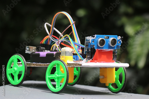 Human following robot vehicle built at home using electronics component such as ultrasonic sensor and infrared sensor with micro controller