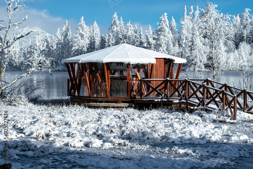 beautiful snowland scenery with hotel, lake and snowy trees in winter wonder fairytale