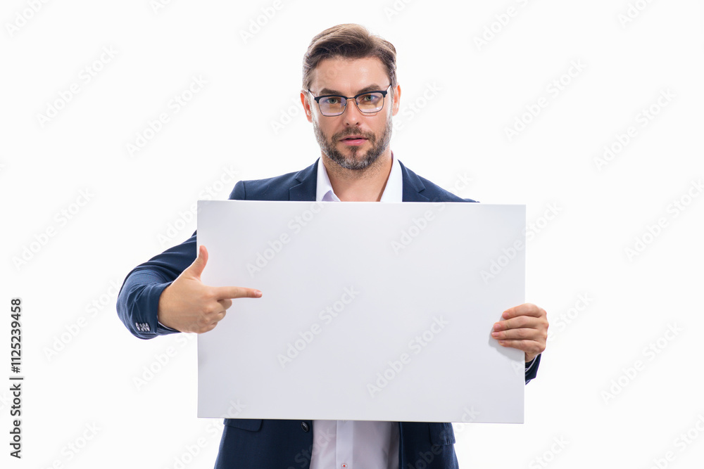 Business man in suit with blank banner, isolated on studio background. Man holding empty blank poster pointing finger and gesturing index finger. Male presenting signboard, billboard or banner. Business man in suit with blank banner, isolated on studio background. Man holding empty blank poster pointing finger and gesturing index finger. Male presenting signboard, billboard or banner.