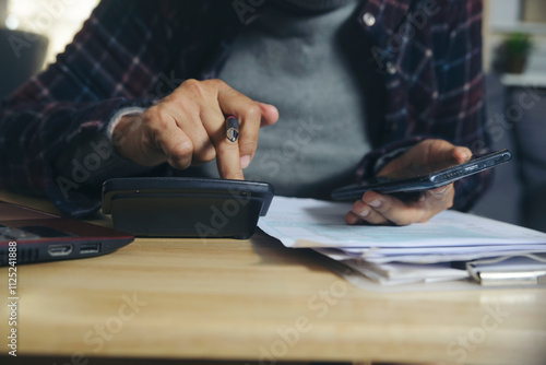 Budget and Tax planning concept. Acountant hand using calculator and review tax form. Represents personal finance, tax preparation, and budgeting, season to pay tax.