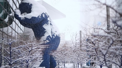 The Big Blue Bear and the Colorado Convention Center during a snowstorm.