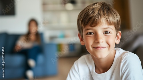 Boy is smiling and looking at the camera