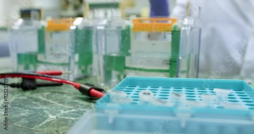 A scientist prepares DNA electrophoresis in a special device, selects a test tube with a sample. Preparation of protein electrophoresis.