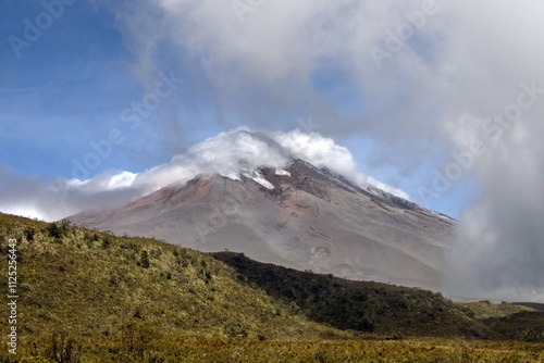 Clouds rolling over Cotopaxi Volcano, while it is erupting with a small ash plume, in Cotopaxi National Park, outside of Quito, Ecuador