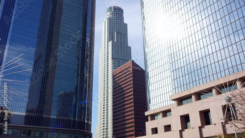 Wallpaper Mural Los Angeles, California - December 4, 2024: Vertical tracking shot showcasing US Bank Tower amidst modern skyscrapers, highlighting the CBRE building and California Plaza. Torontodigital.ca