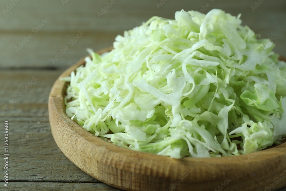 Fresh shredded cabbage on wooden table, closeup Fresh shredded cabbage on wooden table, closeup