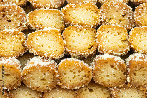 Mouchak Sandesh topped with coconut coating texture closeup side view of Indian, pakistani and bangladeshi sweet dessert food