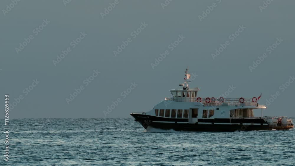 Boat moving on the sea in Cannes, France in the evening Boat moving on the sea in Cannes, France in the evening