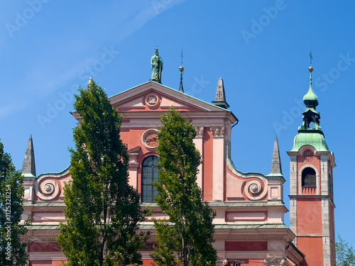 Red and pink Franciscan church top, Ljubljana, Slovenia photo