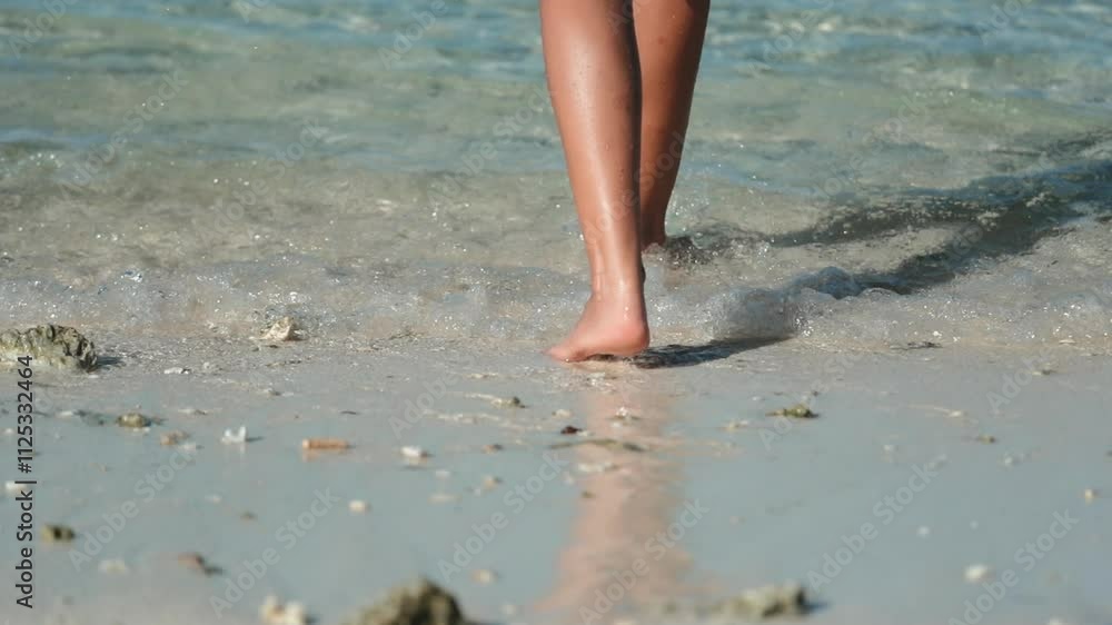Woman walks barefoot on a sunny beach, leaving footprints in the sand, enjoying the warmth of the sun and the sound of crashing waves, feeling relaxed and free in nature's beauty Woman walks barefoot on a sunny beach, leaving footprints in the sand, enjoying the warmth of the sun and the sound of crashing waves, feeling relaxed and free in nature's beauty