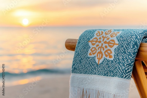 beach towel design, beach chair adorned with coastal motif towels, set against golden sunset and serene waves photo