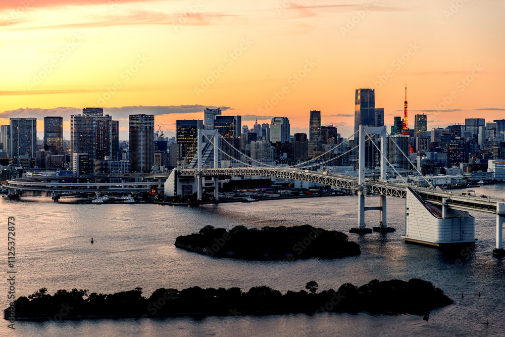 Sunset over the big city Sunset view capturing the Tokyo skyline with the iconic Rainbow Bridge in sight. Sunset over the big city Sunset view capturing the Tokyo skyline with the iconic Rainbow Bridge in sight.
