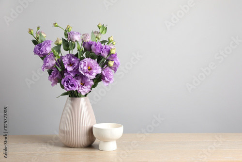 Wallpaper Mural Vase with beautiful eustoma flowers on wooden table, space for text Torontodigital.ca